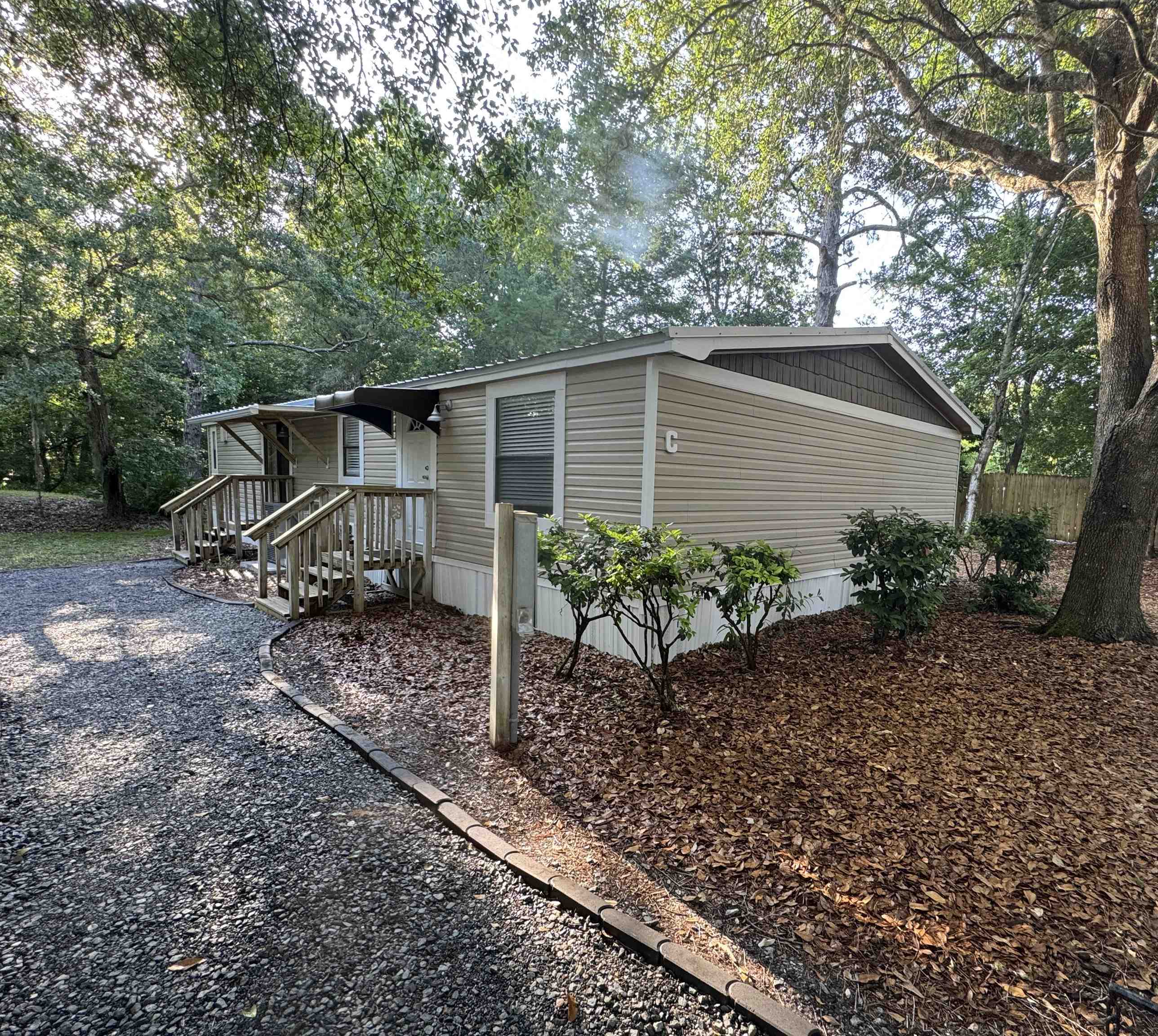 4430 Manucy Road, Unit C St. Augustine, FL 32084 - Photo 2 of 26 a front view of a house with garden