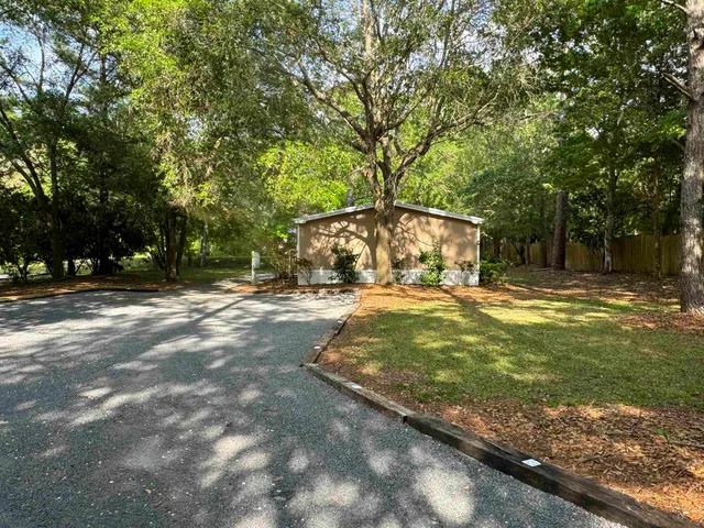 a view of yard with swimming pool and trees