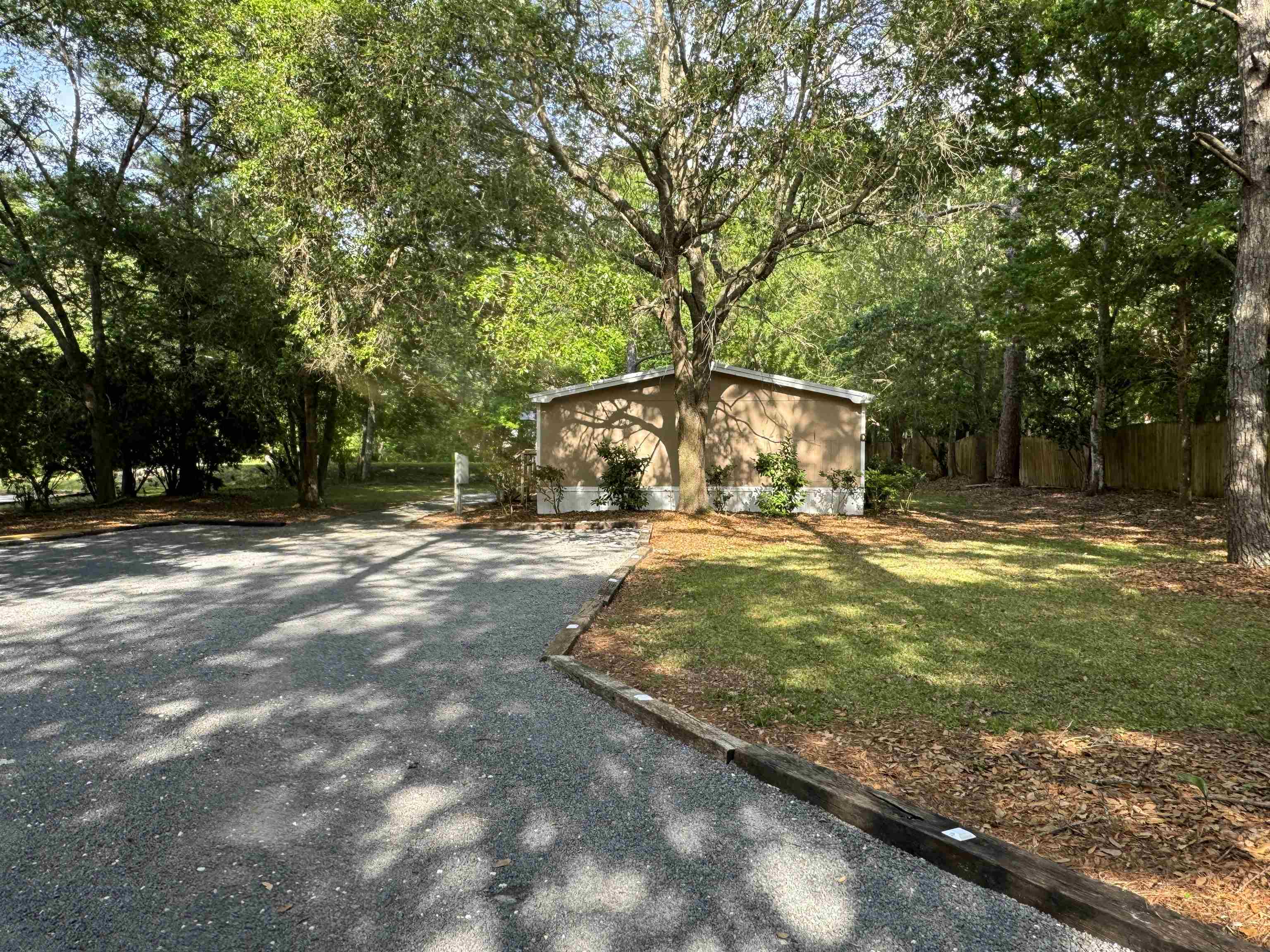 4430 Manucy Road, Unit C St. Augustine, FL 32084 - Photo 23 of 26 a view of yard with swimming pool and trees