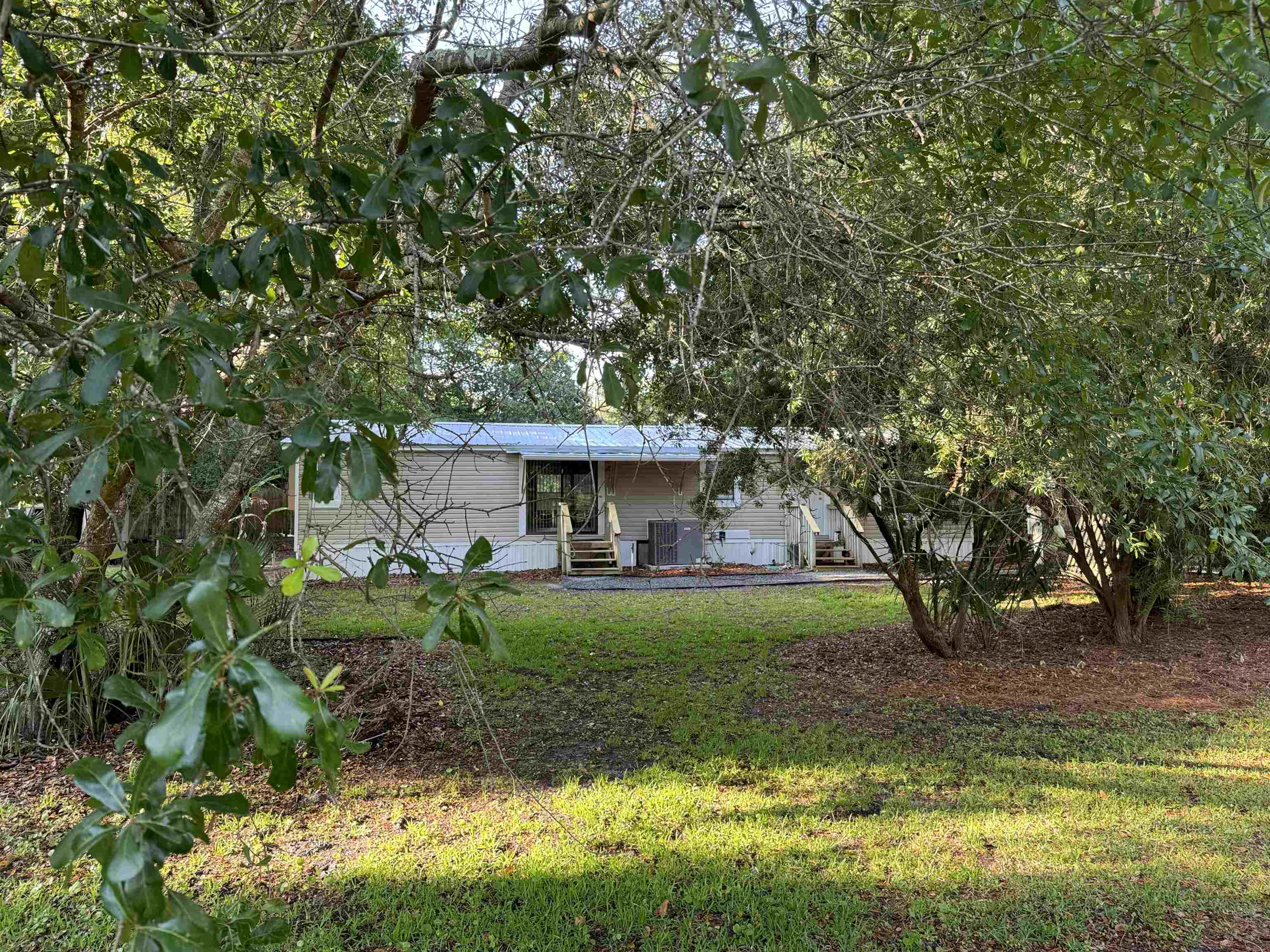 4430 Manucy Road, Unit C St. Augustine, FL 32084 - Photo 25 of 26 a view of a house with a yard