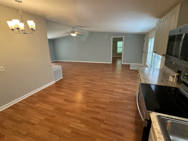 a view of kitchen cabinets and wooden floor
