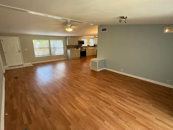 wooden floor in an empty room with a window