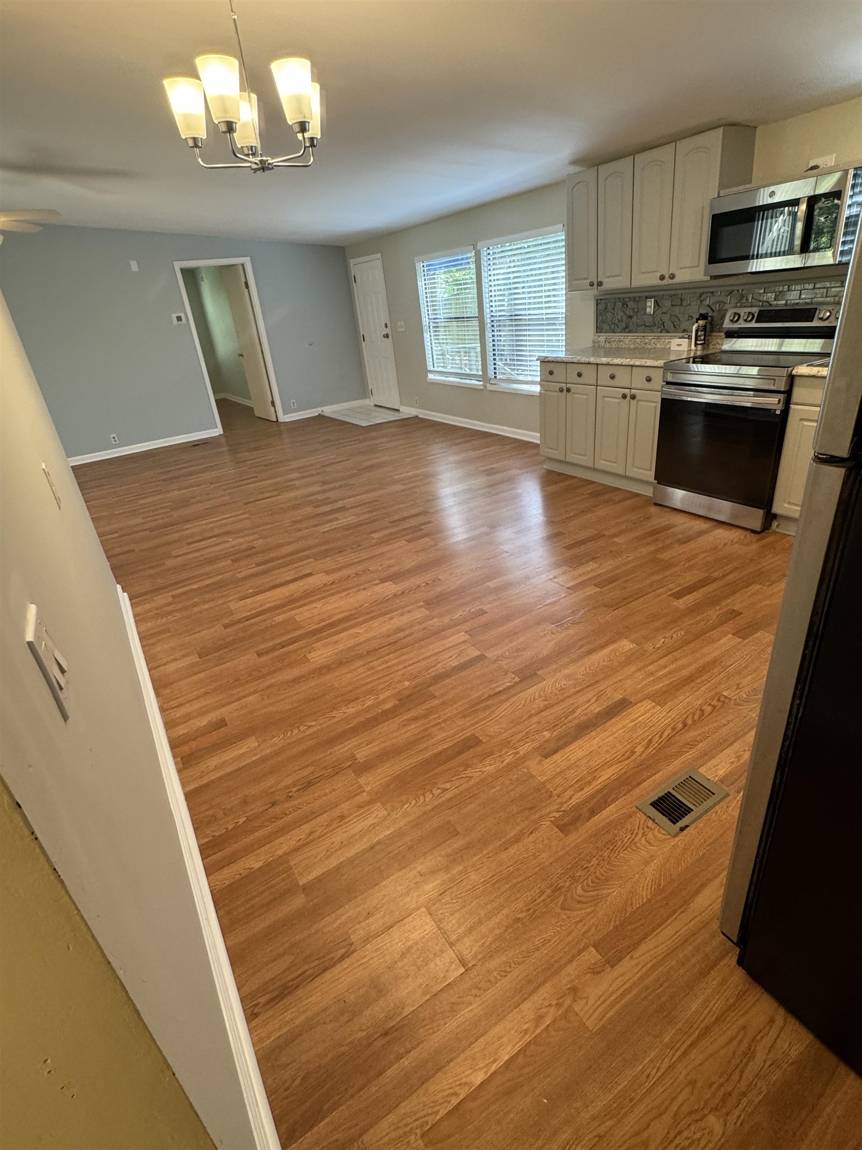 4430 Manucy Road, Unit C St. Augustine, FL 32084 - Photo 7 of 26 a view of a kitchen with a sink and dishwasher wooden floor
