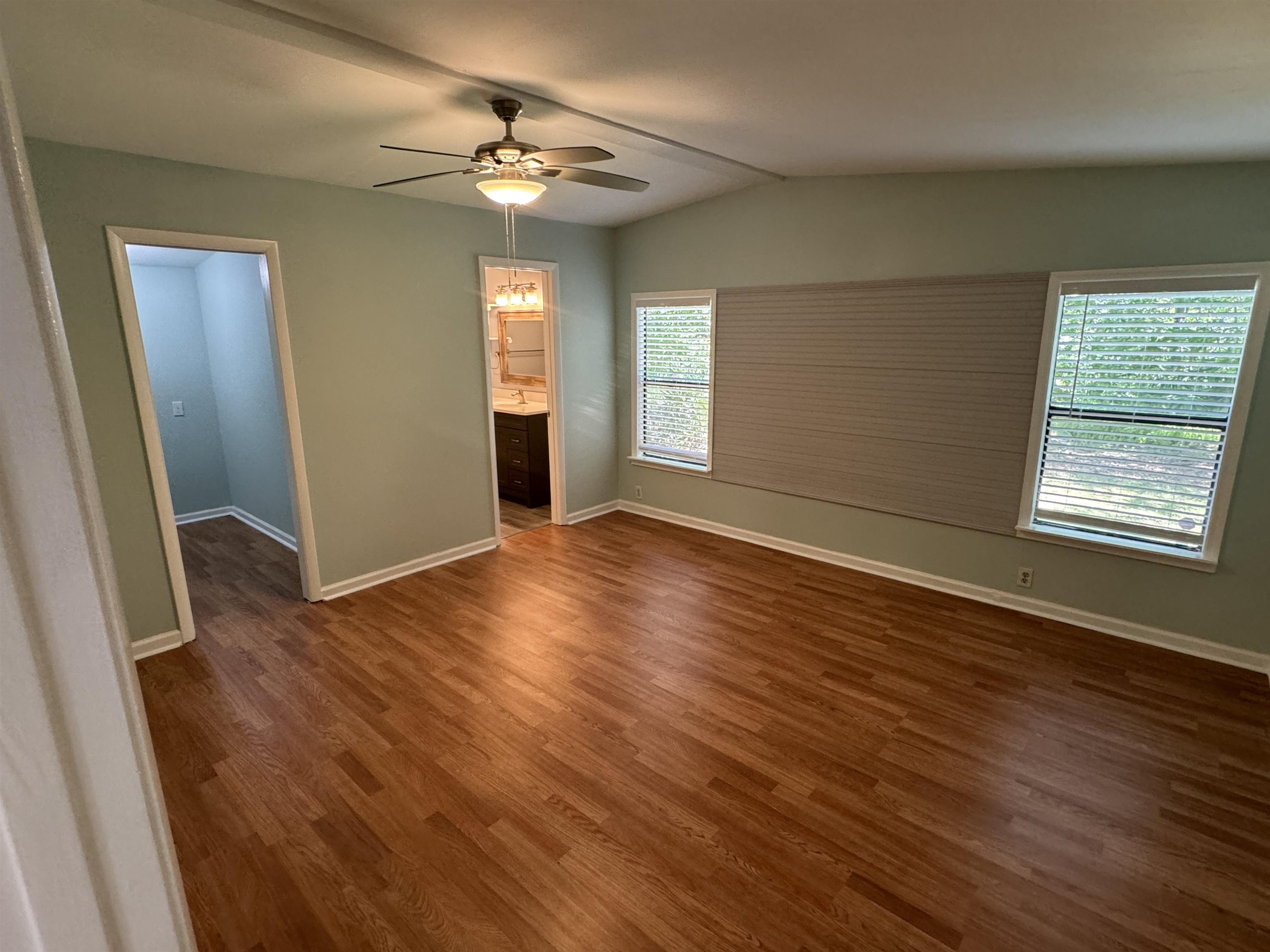 4430 Manucy Road, Unit C St. Augustine, FL 32084 - Photo 9 of 26 an empty room with wooden floor fan and windows