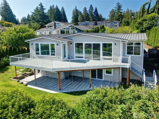 a view of a house with a backyard porch and sitting area