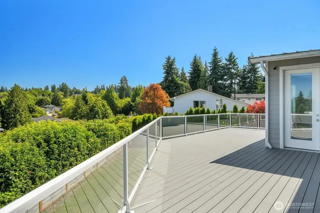 a view of a balcony with wooden floor and fence