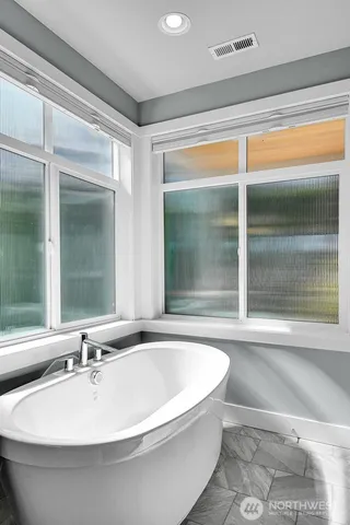 a bathroom with a bathtub and a sink