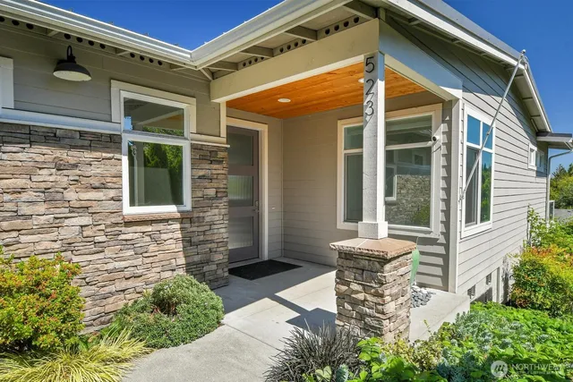 a front view of a house with outdoor seating