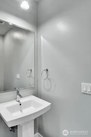 a bathroom with a sink and mirror