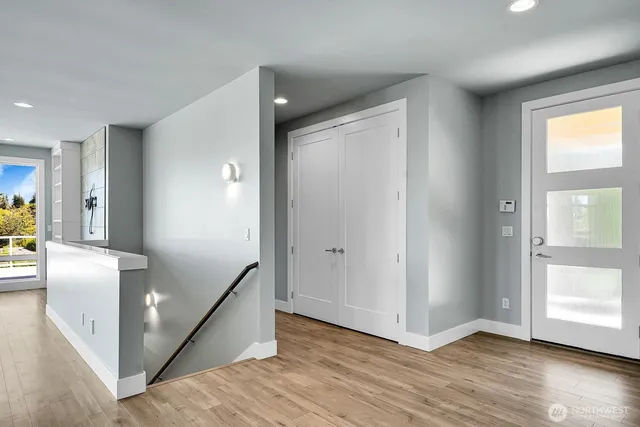 a view of hallway with wooden floor