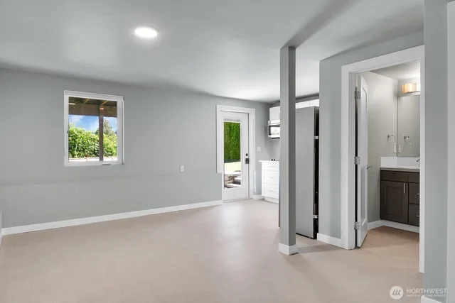 an empty room with windows and closet