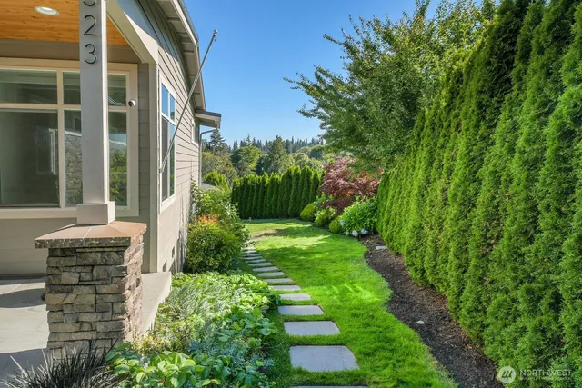 a view of house with backyard and garden