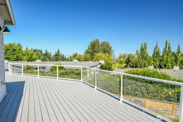 a view of a balcony with wooden floor and fence