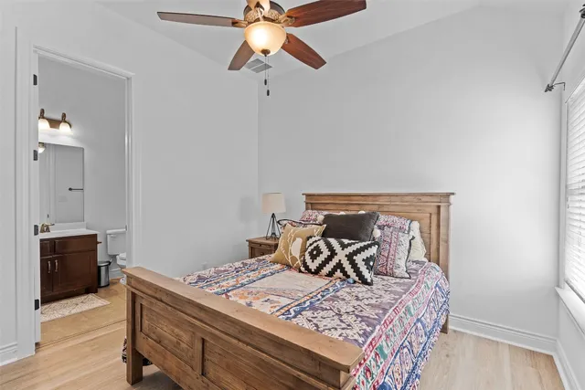 a bed sitting in a bedroom next to a window