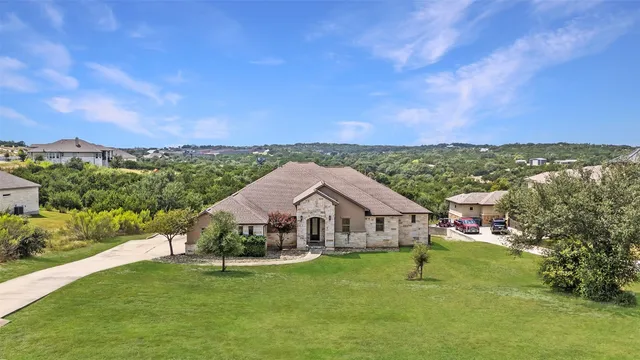 a aerial view of a house with swimming pool and a yard