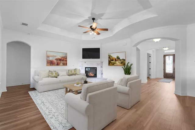 a living room with furniture a fireplace and a flat screen tv