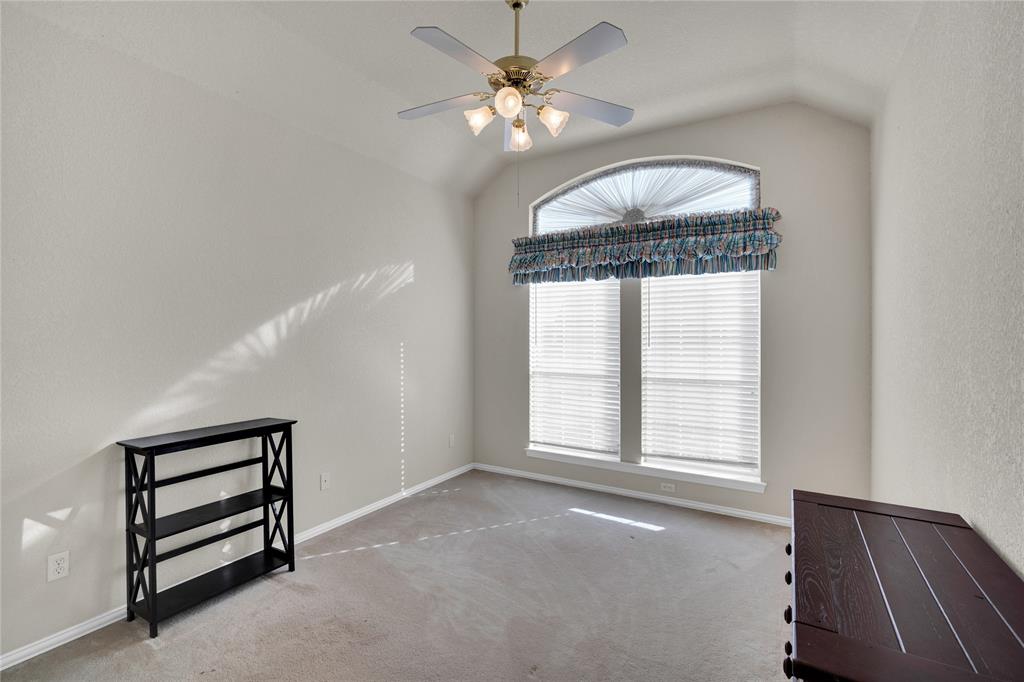 530 Queens Way Grand Prairie, TX 75052 - Photo 21 of 32 an empty room with windows and fan
