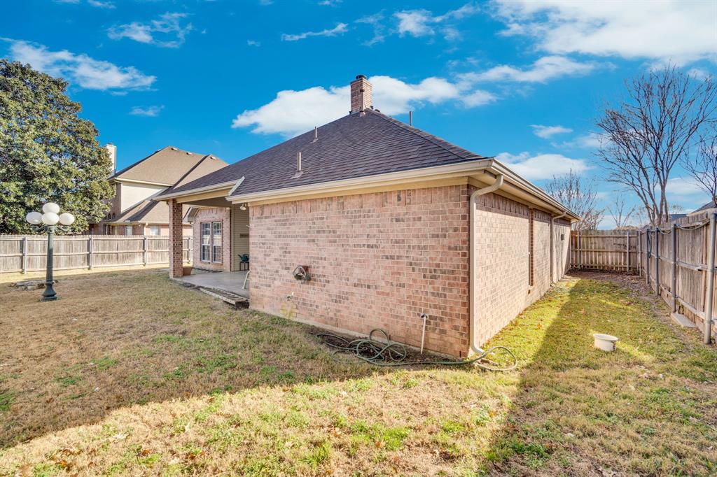 530 Queens Way Grand Prairie, TX 75052 - Photo 25 of 32 a view of a house with a yard