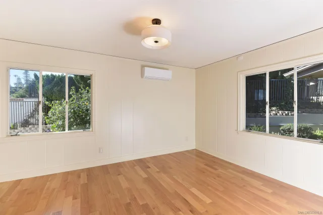 a bathroom with a granite countertop sink a toilet and a mirror