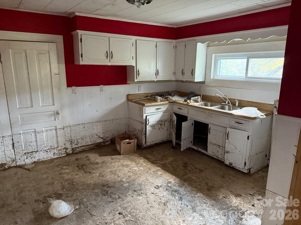 166 Old Helton School Road Lansing, NC 28643 - Photo 11 of 24 a kitchen with a sink stove and cabinets