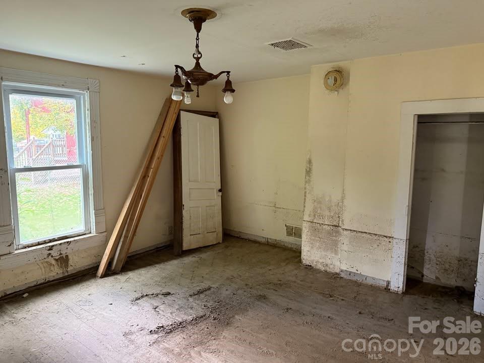166 Old Helton School Road Lansing, NC 28643 - Photo 17 of 24 a view of a livingroom with wooden floor and a ceiling fan