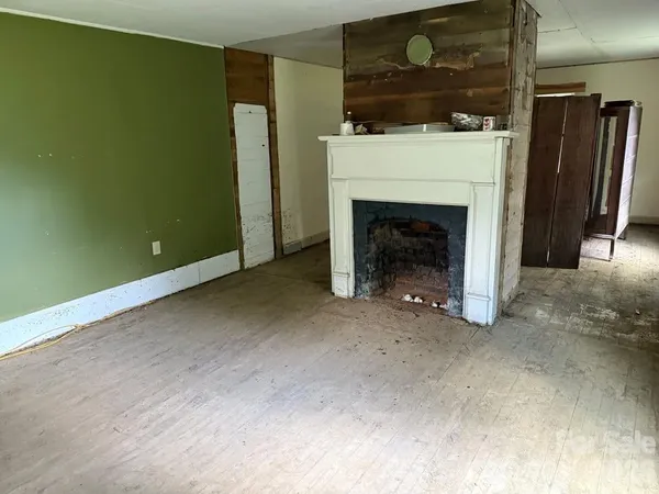 a view of an empty room with a fireplace