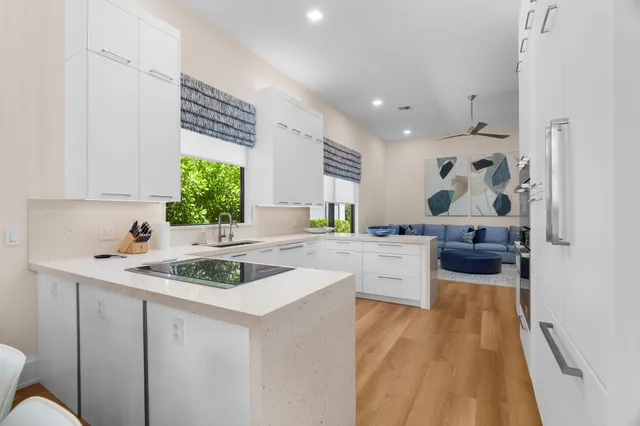 a kitchen that has a sink and a stove in it