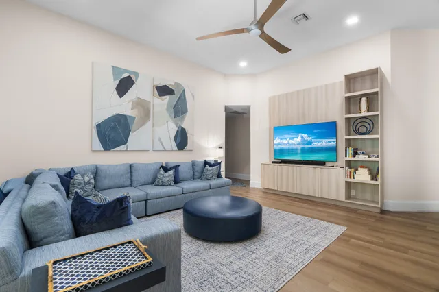 a living room with furniture and a potted plant
