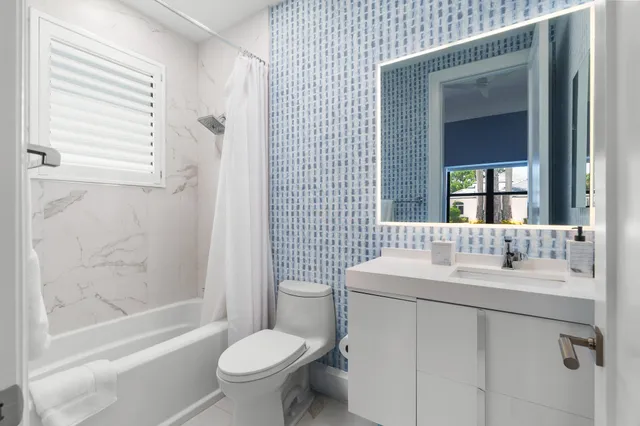 a bedroom with a bed and a view of kitchen