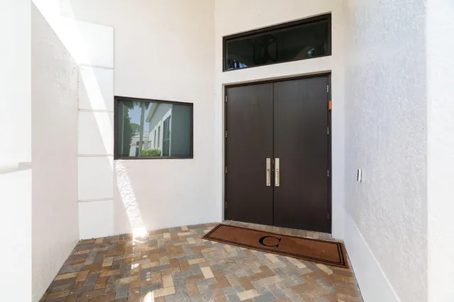 a view of an empty room with wooden floor and cabinet