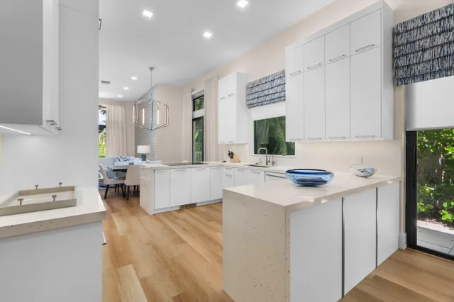 a large kitchen with kitchen island a sink appliances and cabinets