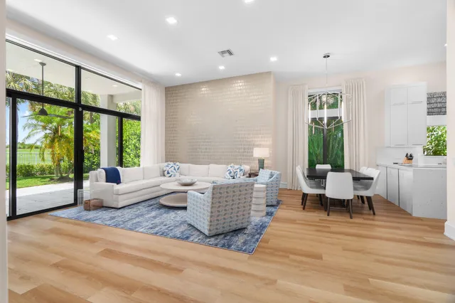 a living room with furniture and large windows