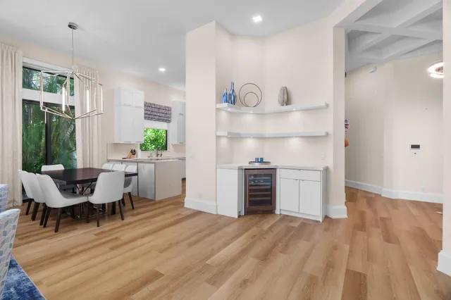 a living room with furniture and kitchen view