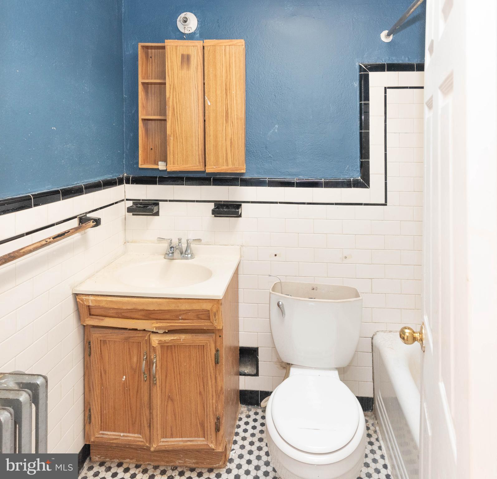 3706 Cranston Avenue Baltimore, MD 21229 - Photo 11 of 29 a bathroom with a sink a toilet and mirror