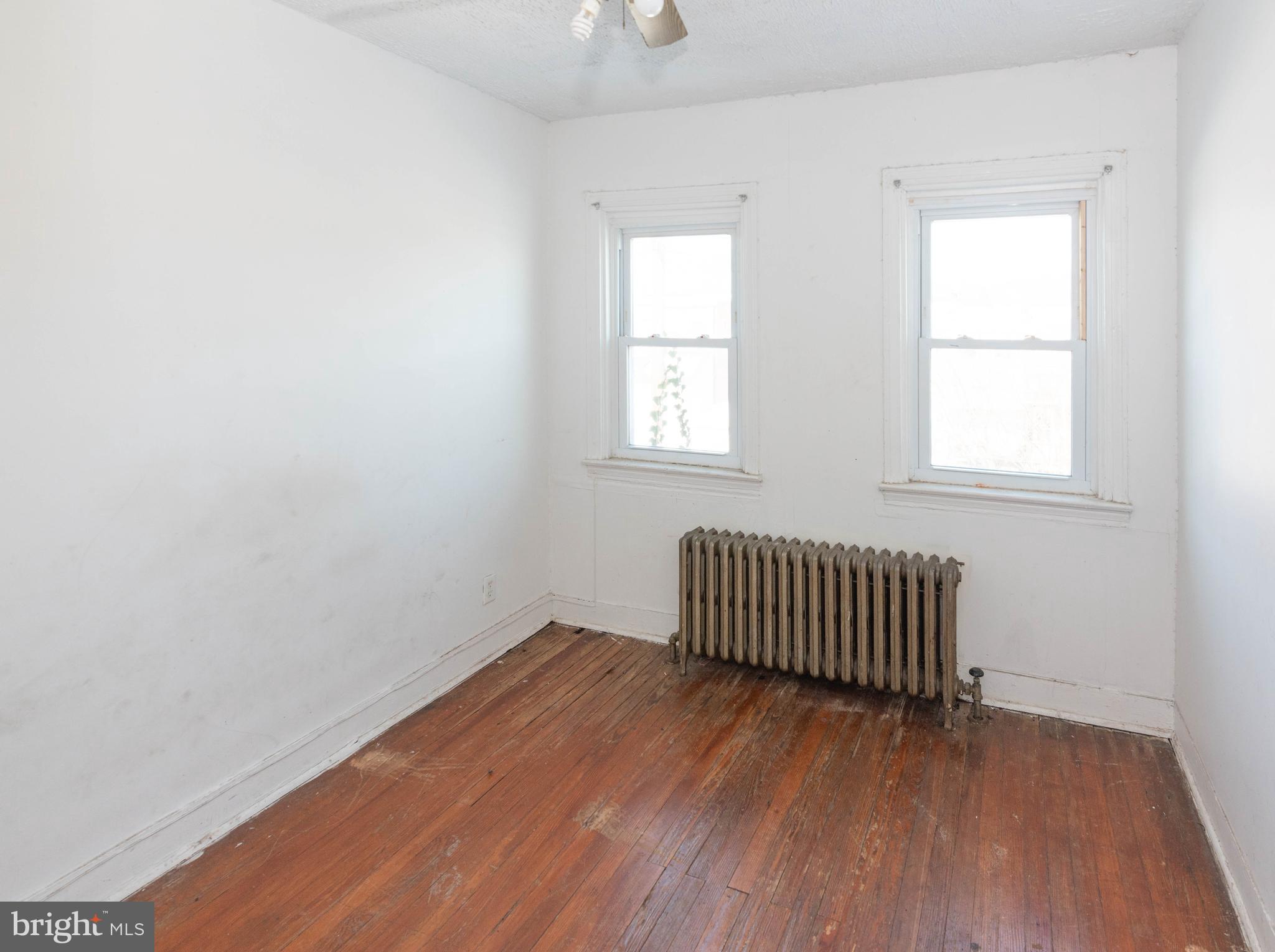 3706 Cranston Avenue Baltimore, MD 21229 - Photo 16 of 29 an empty room with wooden floor and windows