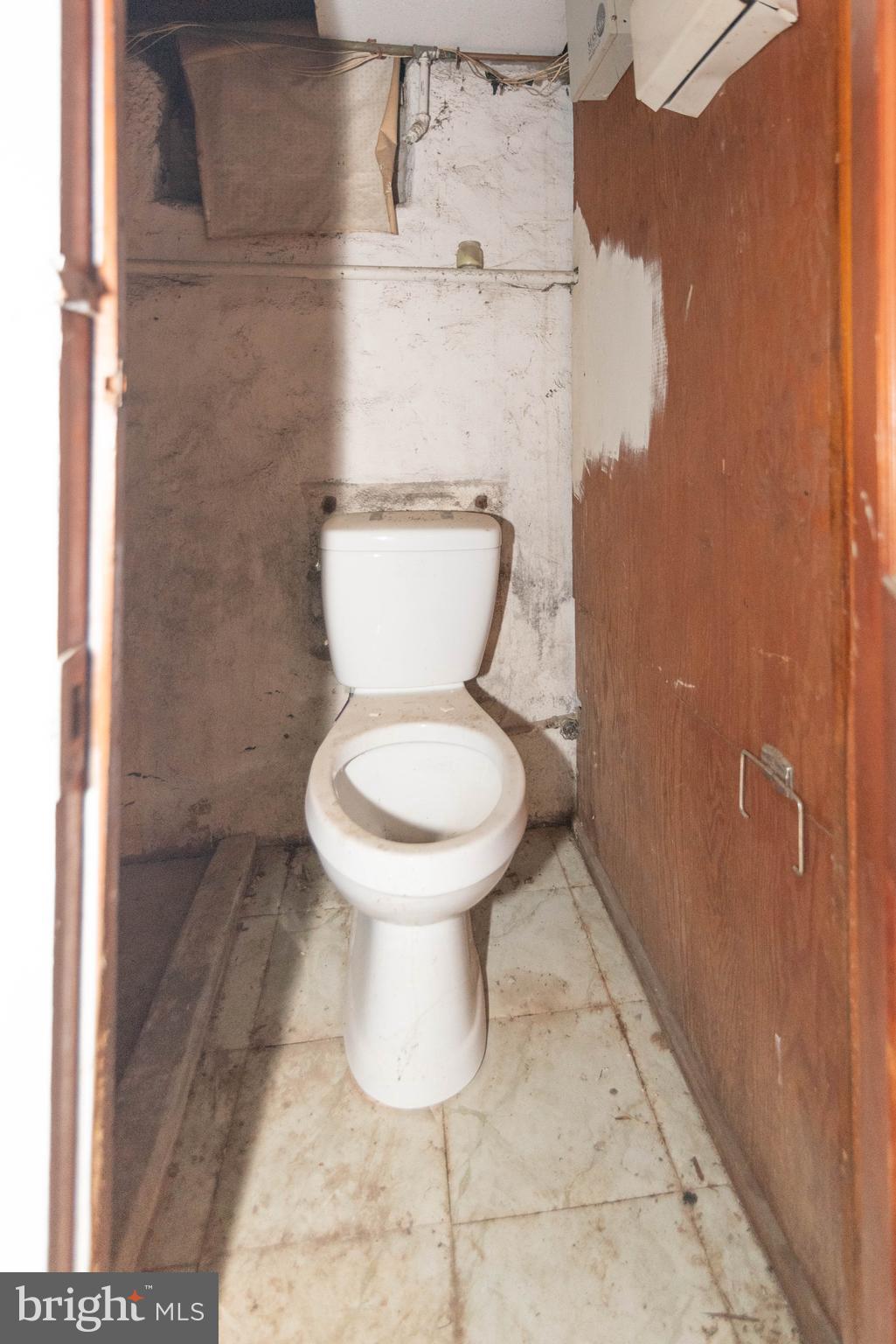 3706 Cranston Avenue Baltimore, MD 21229 - Photo 25 of 29 a white toilet sitting next to a shower