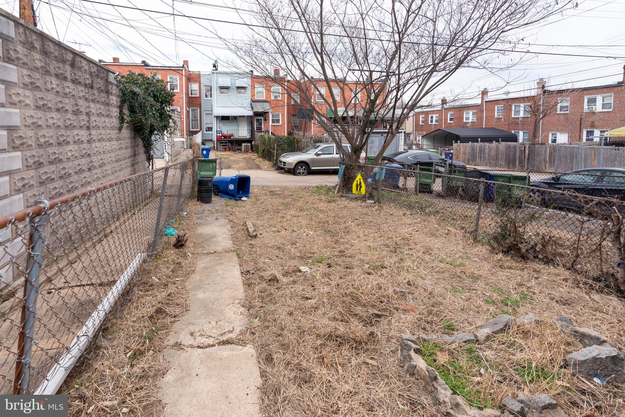 3706 Cranston Avenue Baltimore, MD 21229 - Photo 29 of 29 a backyard of a house with fire pit and trees