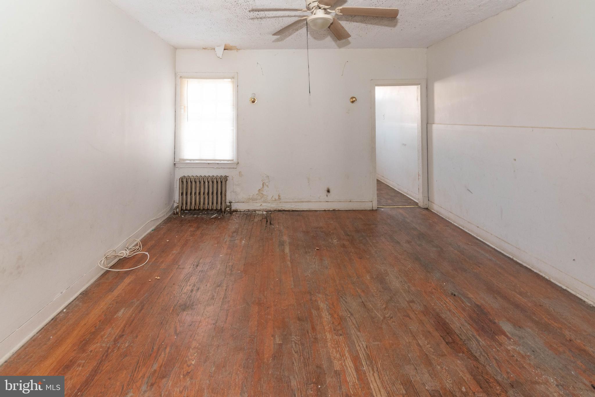 3706 Cranston Avenue Baltimore, MD 21229 - Photo 4 of 29 an empty room with wooden floor and windows