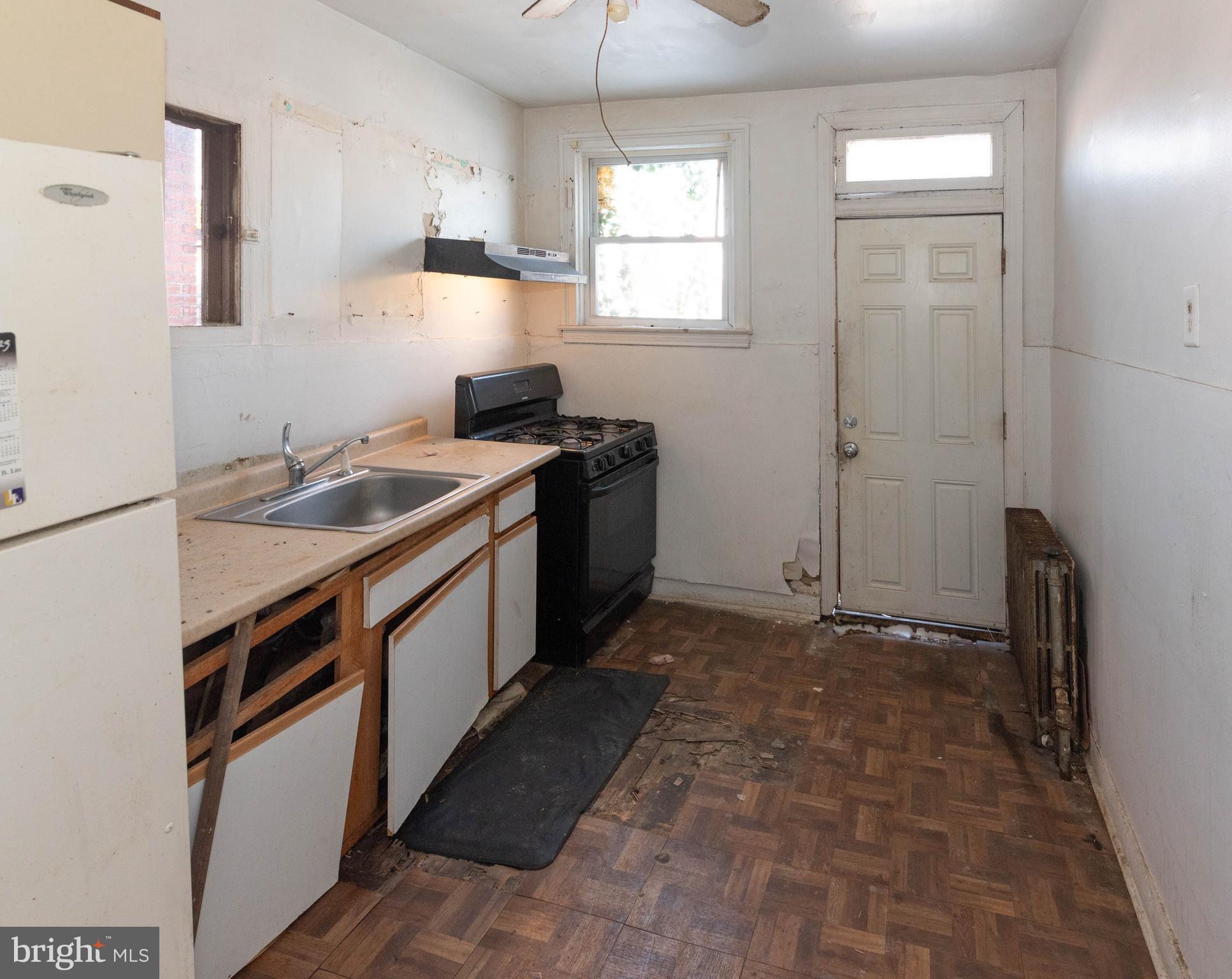 3706 Cranston Avenue Baltimore, MD 21229 - Photo 6 of 29 a kitchen with a sink stove and refrigerator