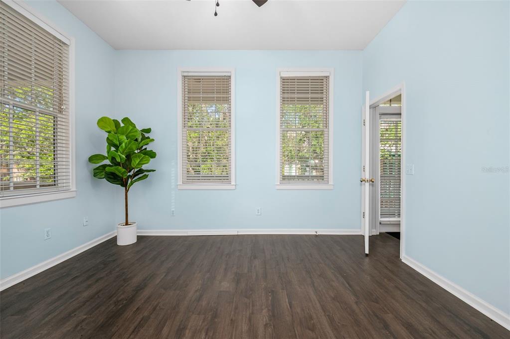 5213 Southwest 91 Terrace, Unit B Gainesville, FL 32608 - Photo 12 of 38 a view of empty room with wooden floor and potted plant
