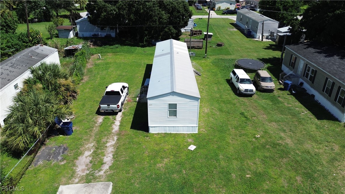 951 Virginia Avenue Clewiston, FL 33440 - Photo 14 of 17 a view of a house with a yard and garden
