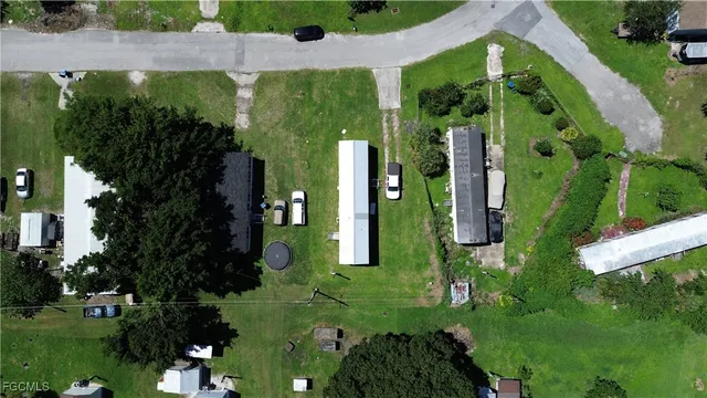 an aerial view of a house having swimming pool a yard and outdoor seating