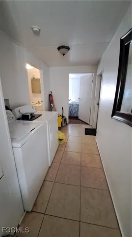 a living room with furniture and a mirror