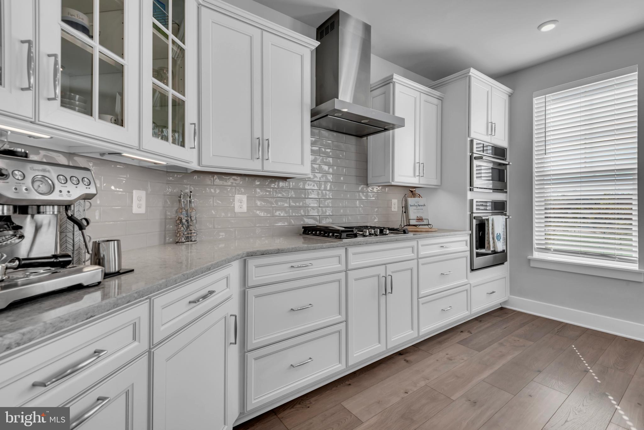 111 Marshgrass Way, Unit 21 Chester, MD 21619 - Photo 11 of 57 a kitchen with stainless steel appliances granite countertop white cabinets and a window