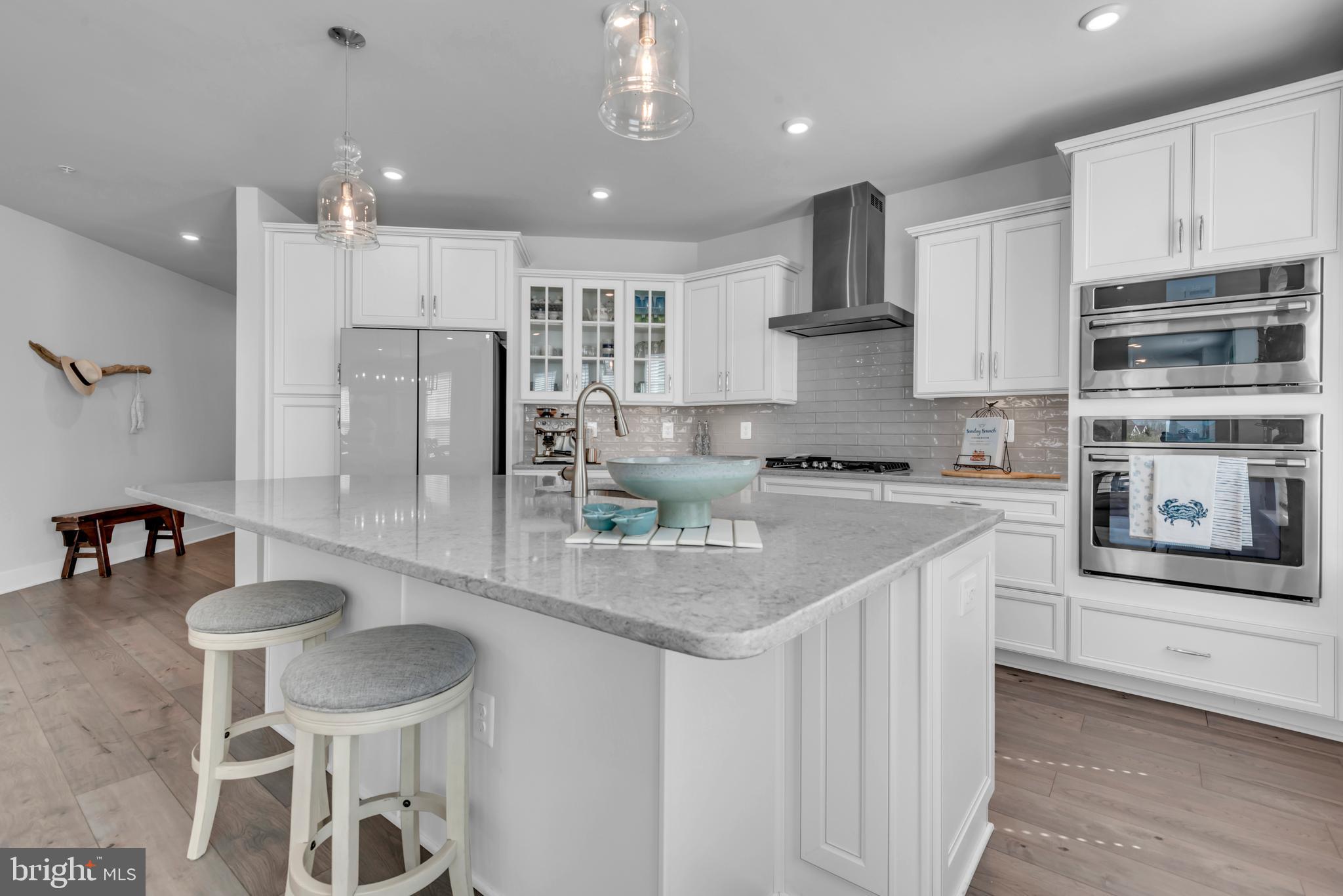 111 Marshgrass Way, Unit 21 Chester, MD 21619 - Photo 14 of 57 a kitchen with stainless steel appliances granite countertop a sink and a refrigerator