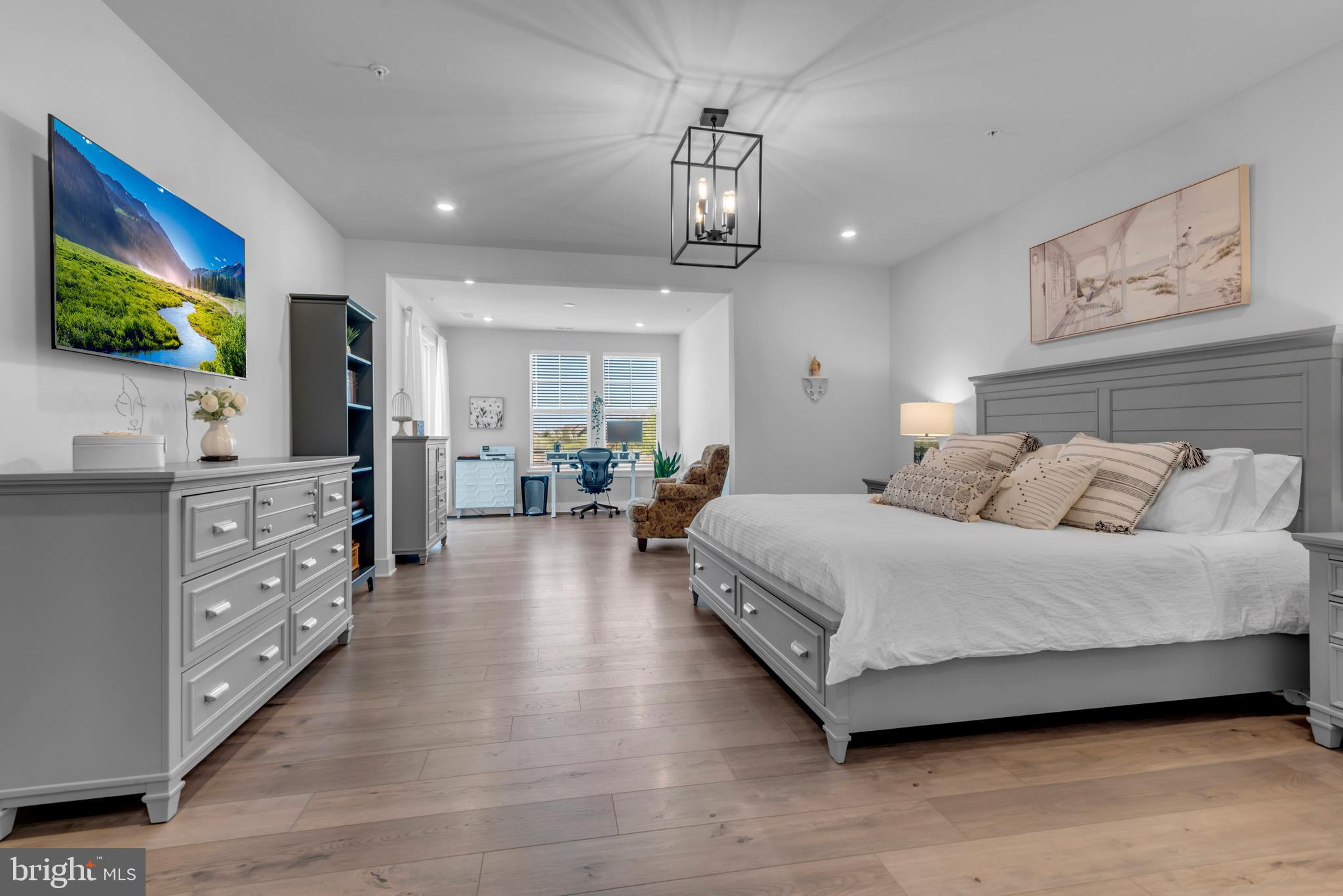111 Marshgrass Way, Unit 21 Chester, MD 21619 - Photo 21 of 57 a spacious bedroom with a bed and a flat screen tv