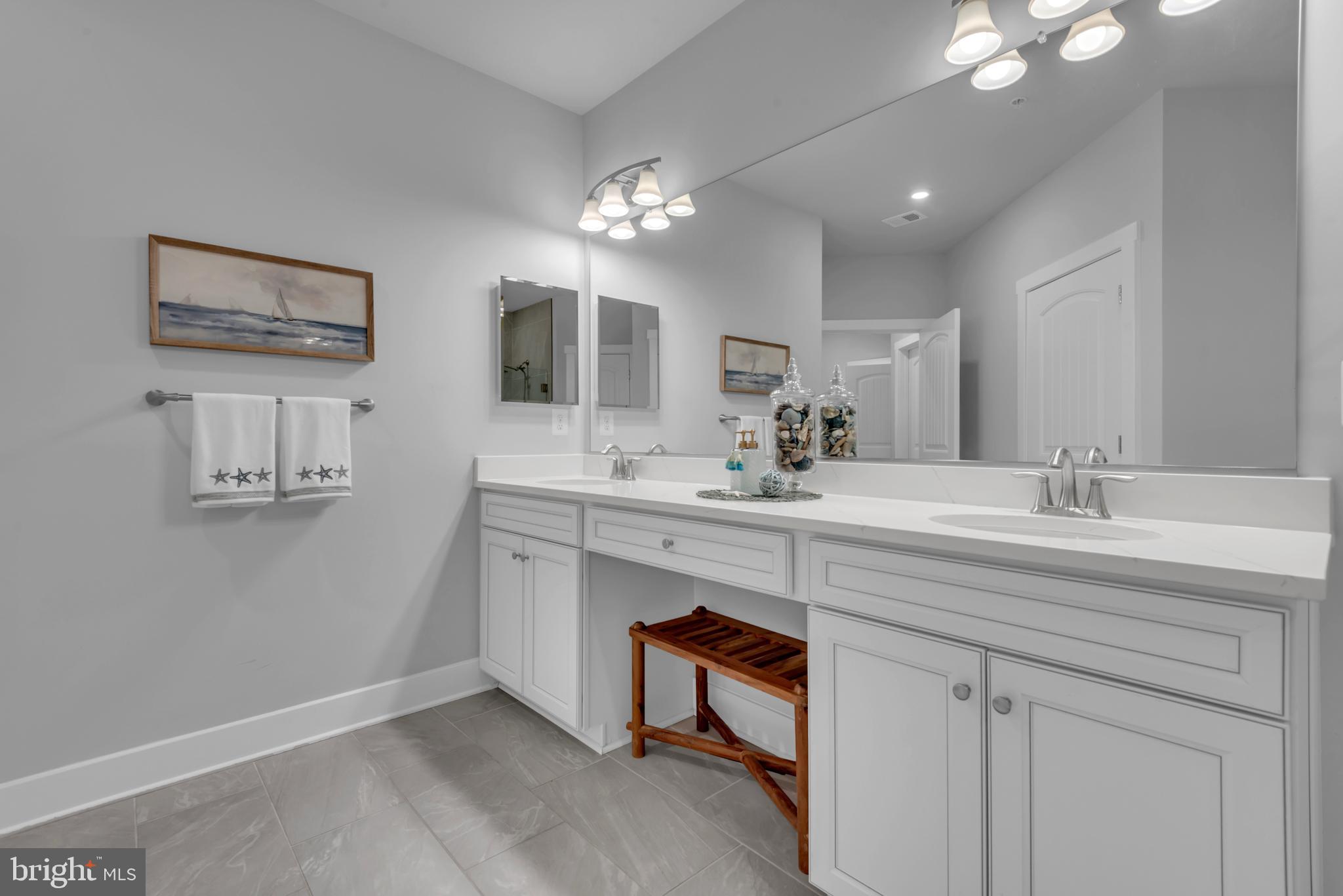 111 Marshgrass Way, Unit 21 Chester, MD 21619 - Photo 26 of 57 a bathroom with a sink vanity and a mirror