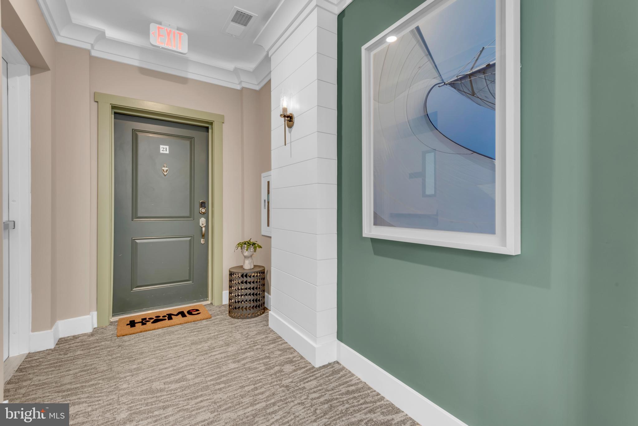 111 Marshgrass Way, Unit 21 Chester, MD 21619 - Photo 3 of 57 a view of a hallway with wooden floor and glass door