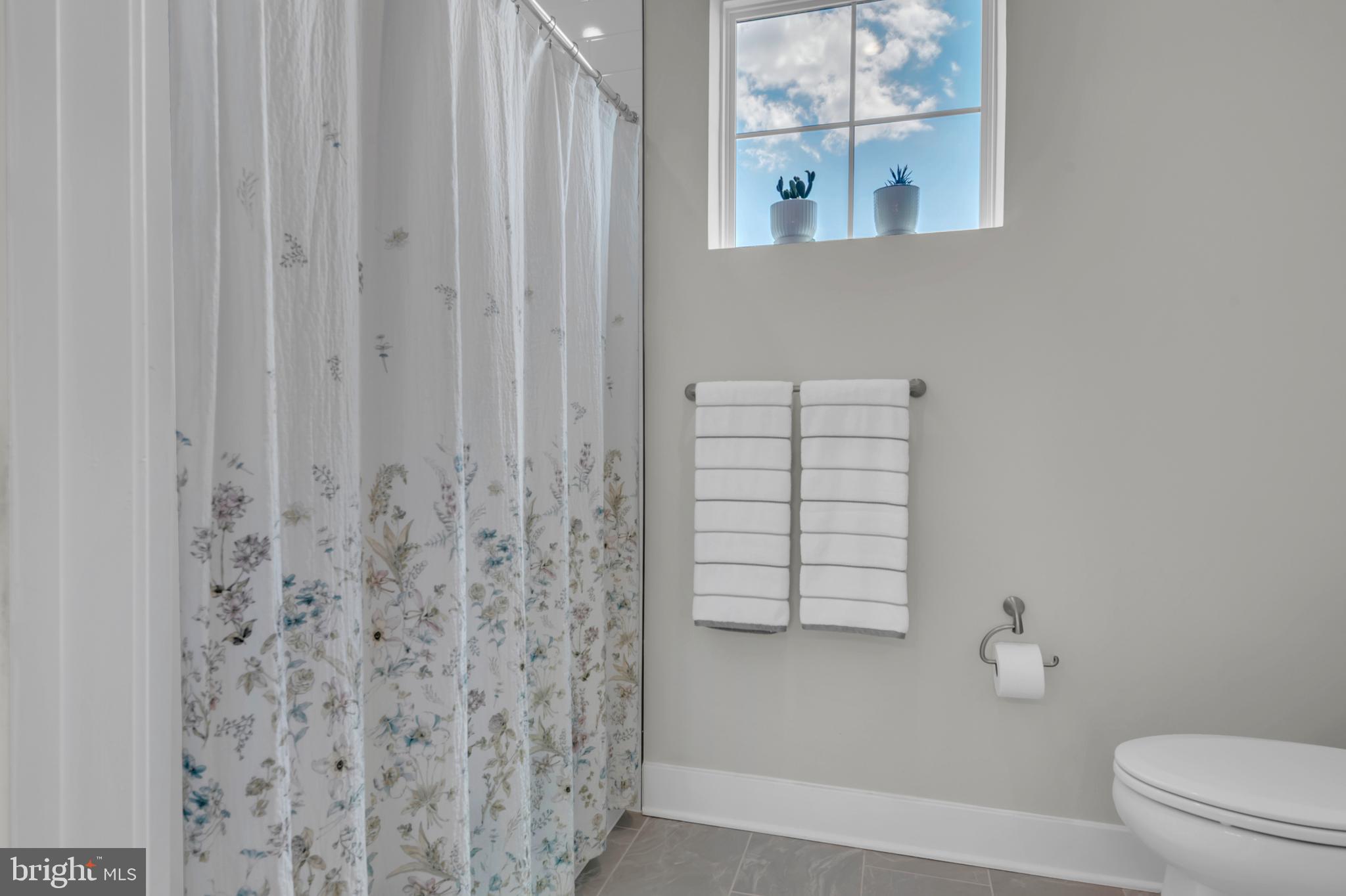 111 Marshgrass Way, Unit 21 Chester, MD 21619 - Photo 33 of 57 a bathroom with a shower curtain