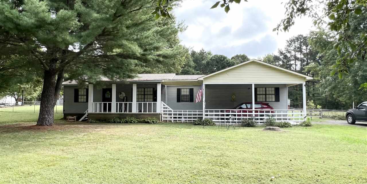 62 Rabbit Trail Road Ripley, TN 38063 - Photo 4 of 11 a front view of a house with a garden and porch